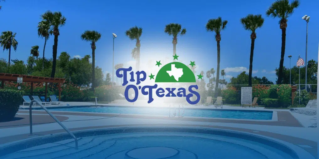 Pool area lined with palm trees at Tip O’ Texas Resort.