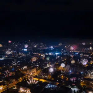 Fireworks over a Georgia city skyline near campgrounds at night.