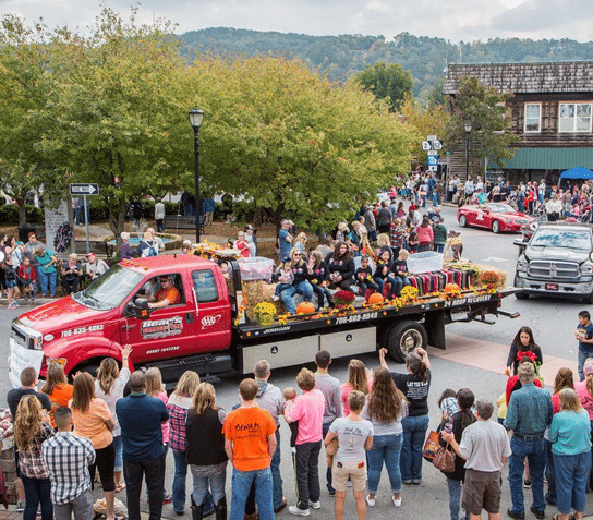 Visitors attending an outdoor festival in a North Georgia town, with local vendors, live music, and community activities.