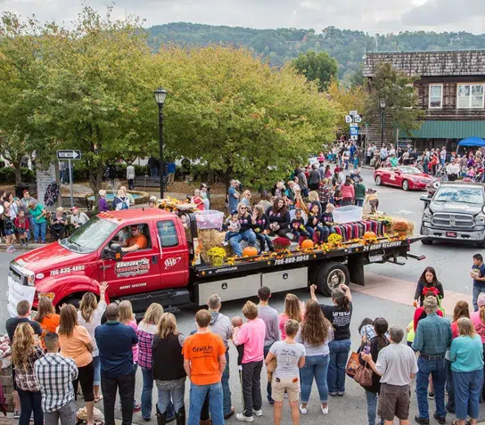Visitors attending an outdoor festival in a North Georgia town, with local vendors, live music, and community activities.