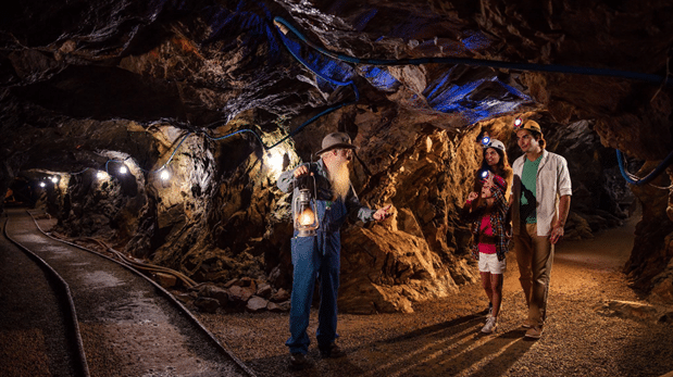 Underground gold mine tunnel in North Georgia, showing historic mining passages and rock walls.