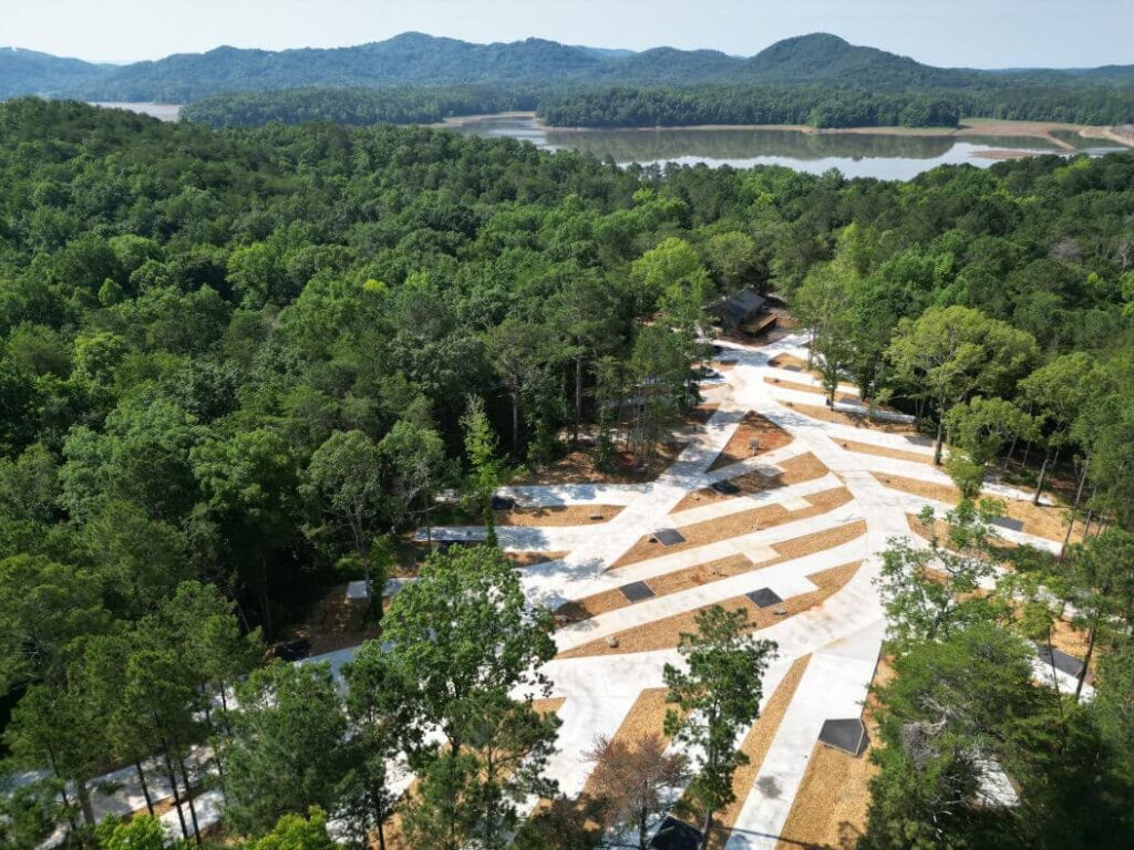 Aerial view of RV sites at Nestle Inn RV Resort surrounded by forest.