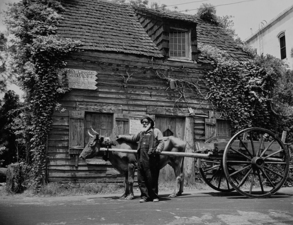 Historic Oldest Wooden School House building in St. Augustine, Florida with wooden structure and garden courtyard.