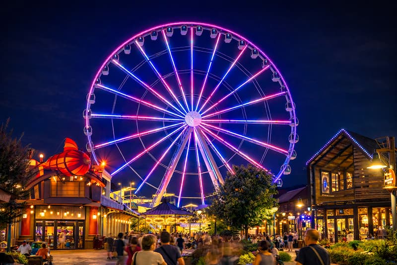 Ferris wheel and entertainment area in Pigeon Forge at night
