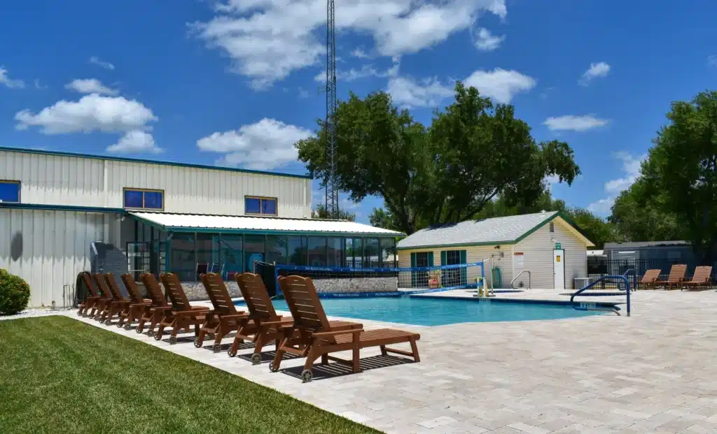 Swimming pool and lounge chairs at Alamo Rose RV Park in Alamo Texas