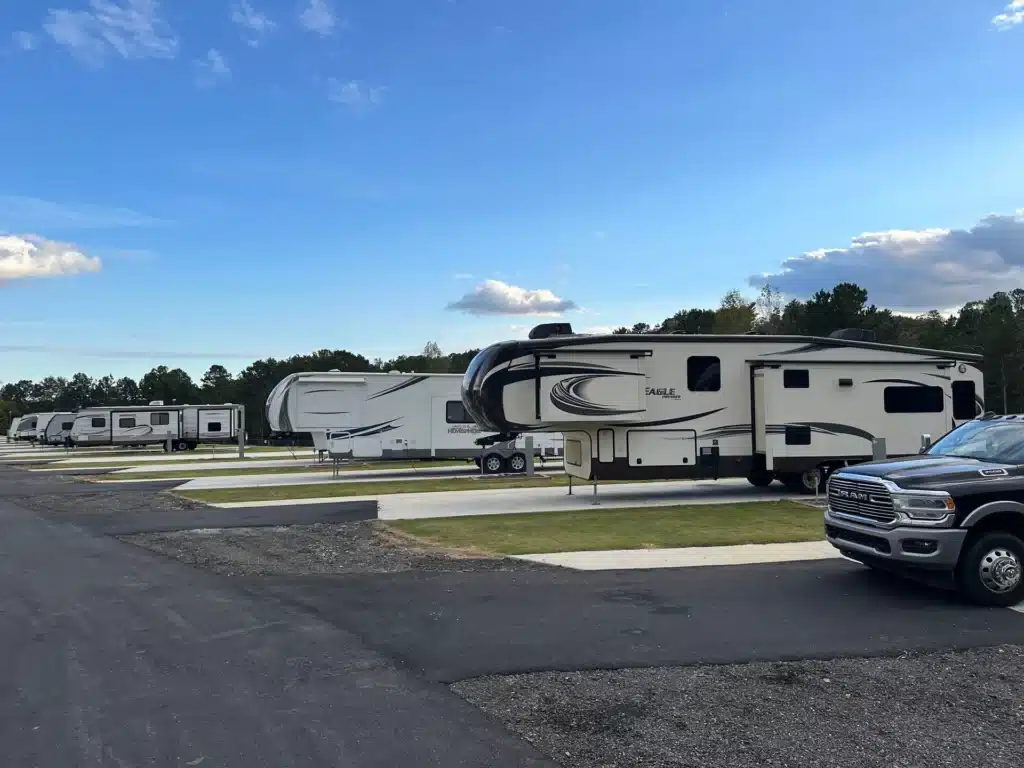 Full hookup RV sites with large fifth-wheel campers parked at a modern campground resort