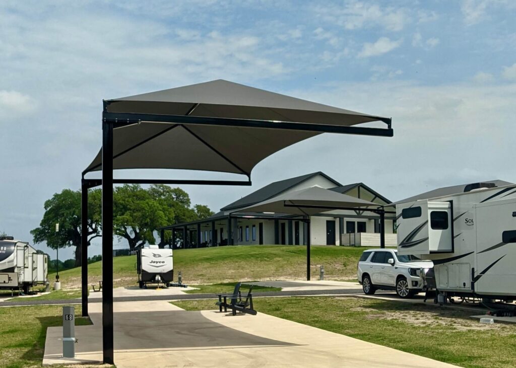 Covered RV campsite with spacious hookup site, shade canopy, and modern campground amenities