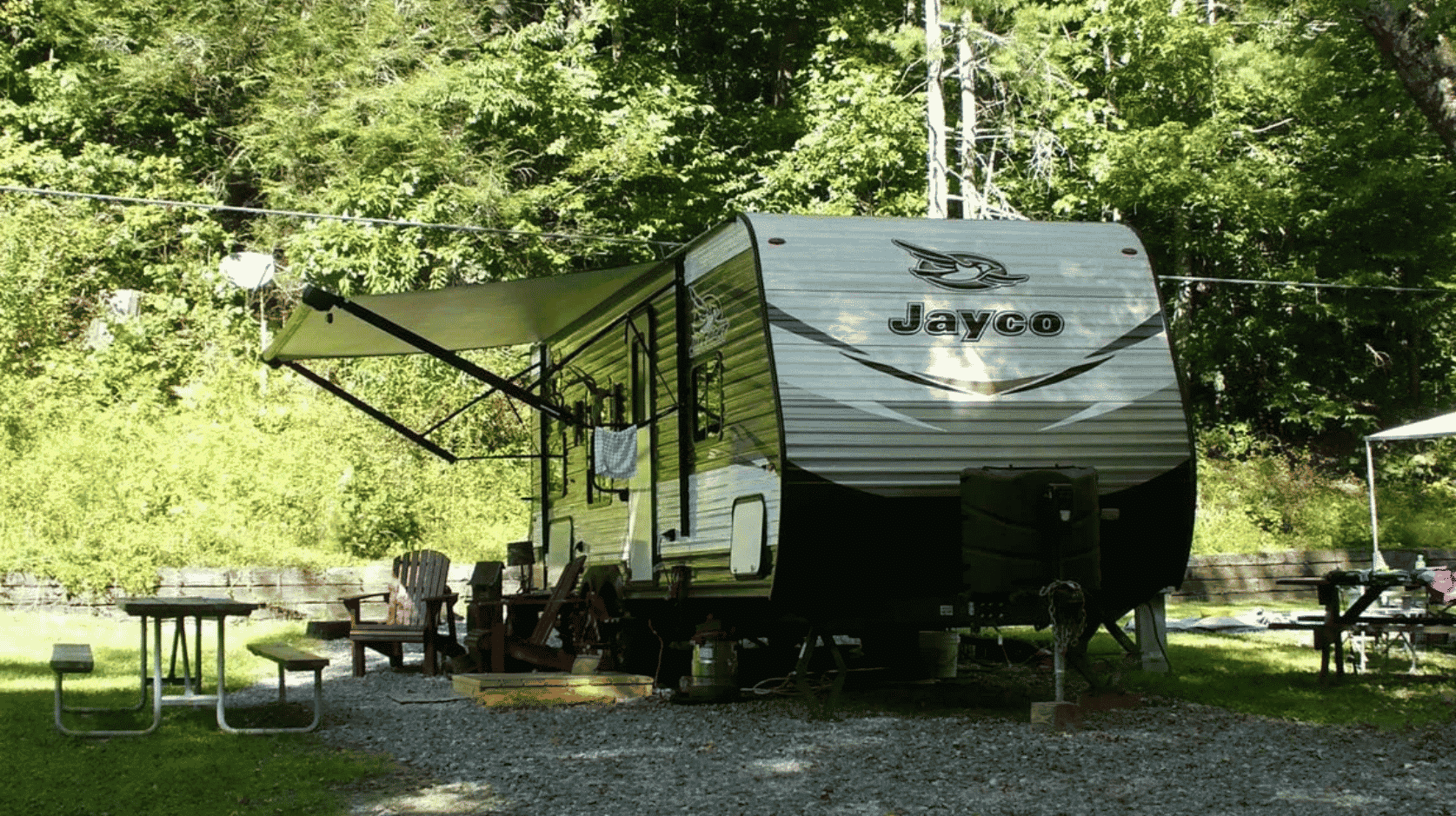 RV camper parked at Whispering Pines Campground surrounded by trees and shaded campsites in North Georgia