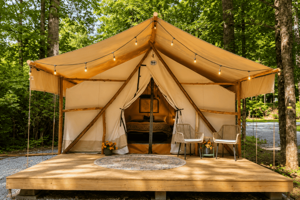 Luxury canvas glamping tent surrounded by trees